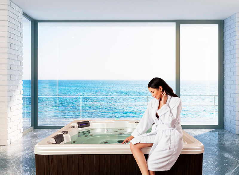 Tropic Seas Spas: woman sitting on edge of hot tub